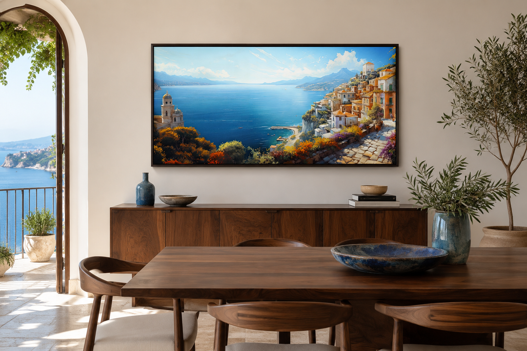 Framed Amalfi Coast canvas print showing a colorful Italian seaside town above a wooden sideboard.
