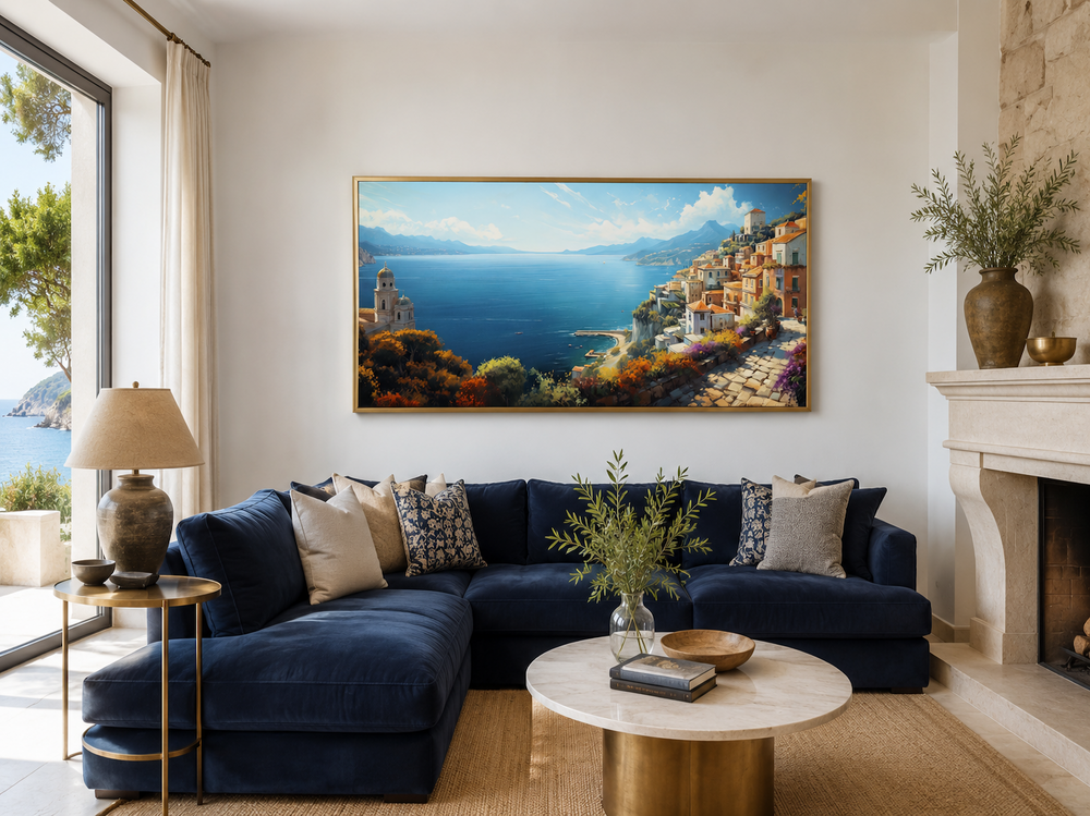 Large framed Amalfi Coast canvas print hanging above a navy blue sectional sofa in a living room.