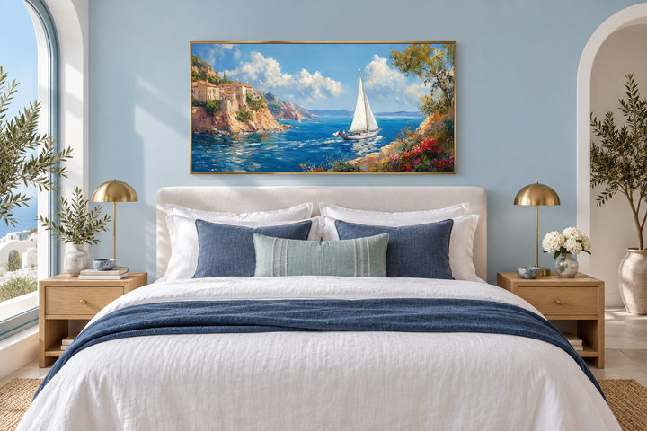 Amalfi Coast with sailboat framed canvas wall art hanging above a bed in a blue bedroom.
