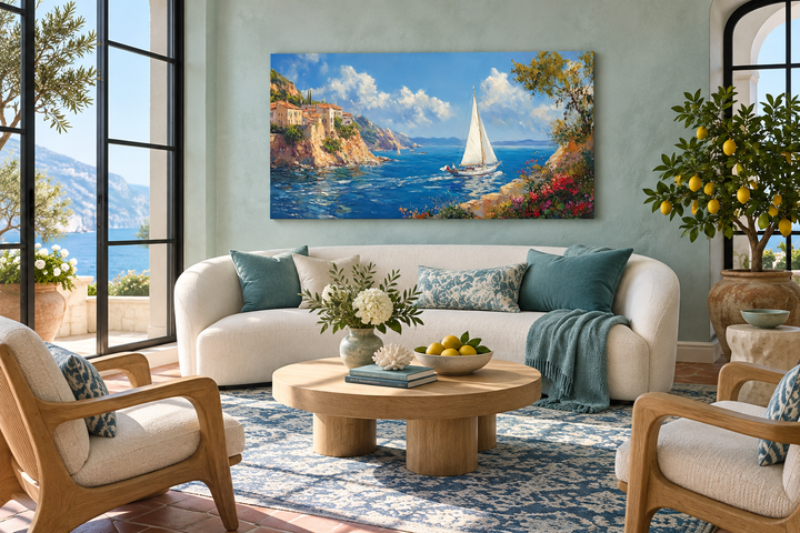 Amalfi Coast with sailboat framed canvas wall art hanging above a white sofa in a coastal living room