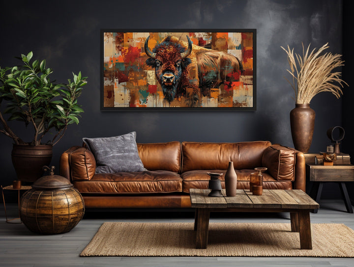 Colorful American Bison canvas wall art in a rustic living room with a brown leather sofa.