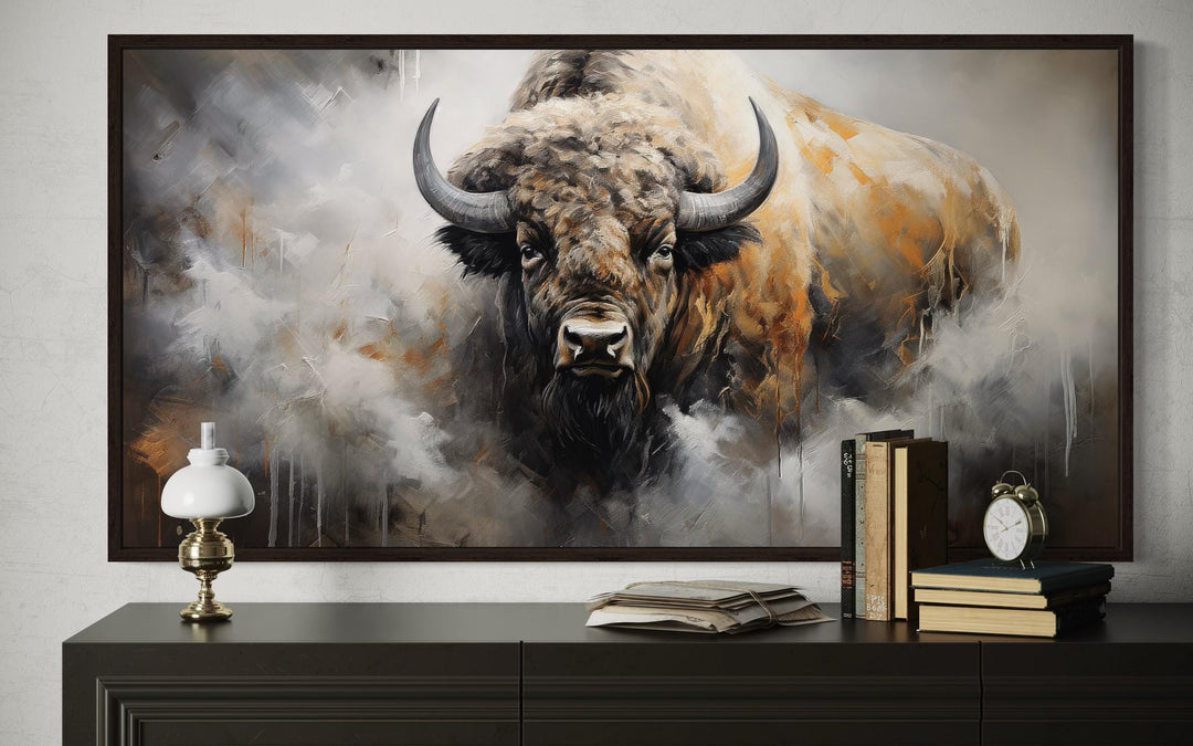 American bison abstract dripping paint framed canvas wall art above a dark wood console table.