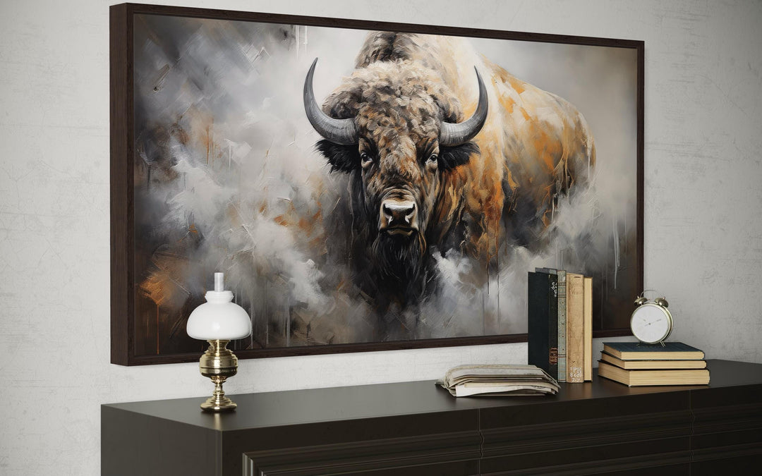 Framed canvas wall art of an American bison in an abstract dripping paint style above a dresser.