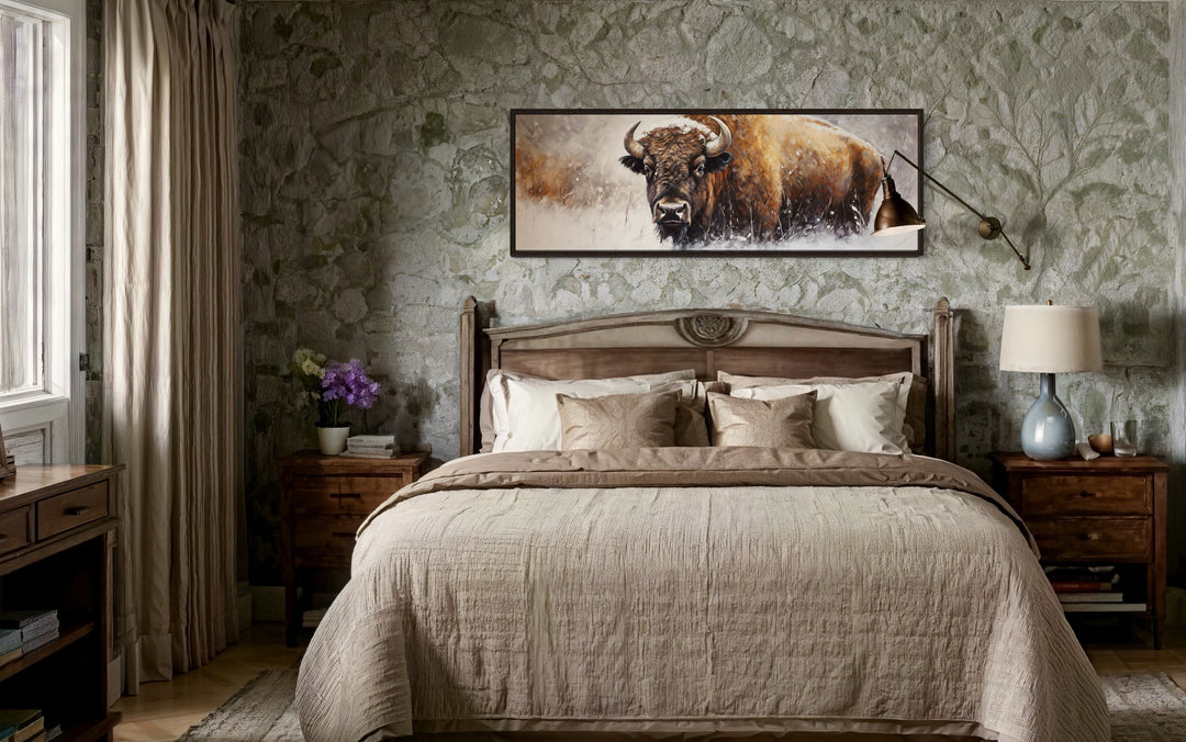 American Buffalo long horizontal framed canvas wall art hanging above a bed in a rustic bedroom.