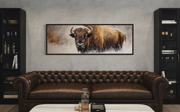 American Buffalo long horizontal framed canvas wall art above a brown leather chesterfield sofa.