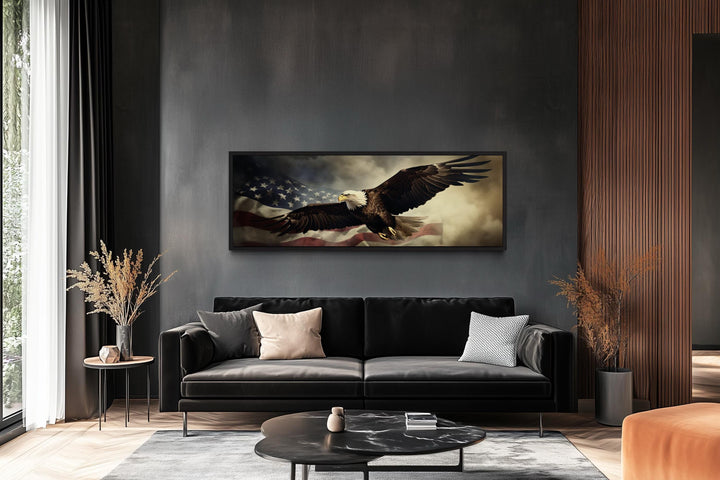 Horizontal wall art of a bald eagle flying over the American flag in a modern dark-walled office.