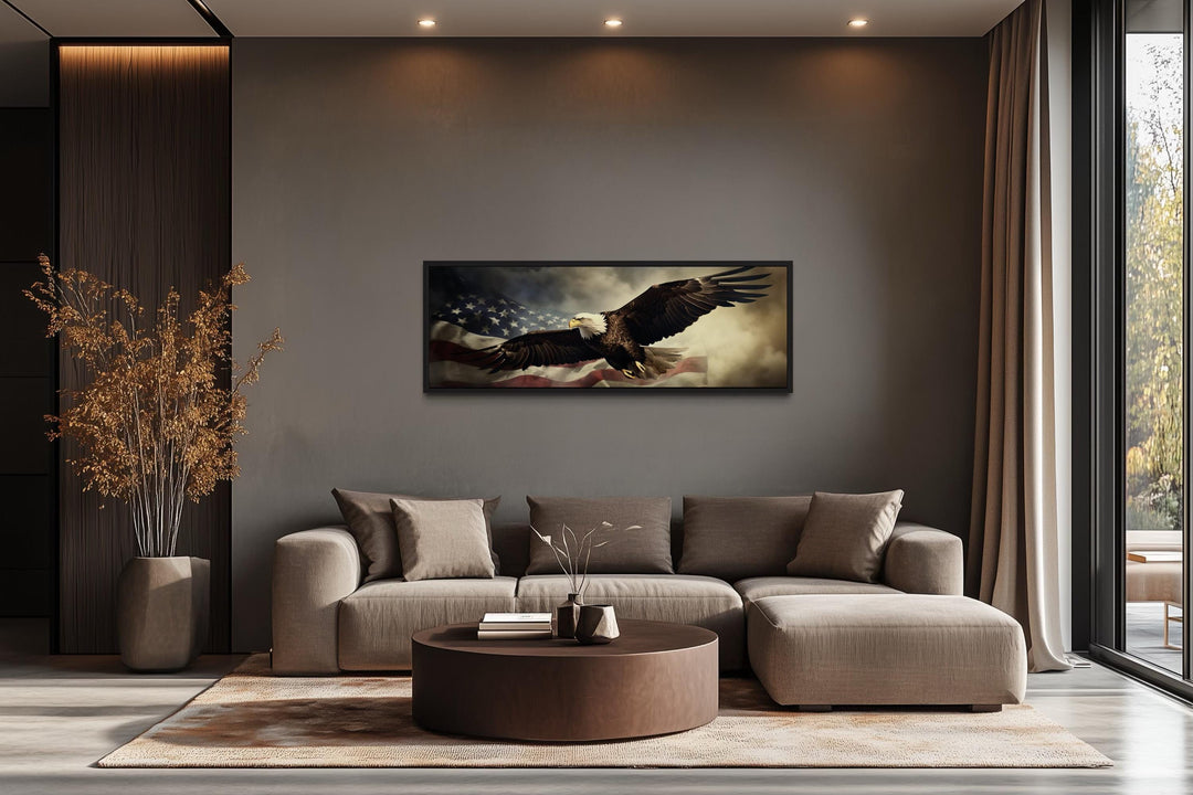 Horizontal wall art of a bald eagle flying over the American flag in a modern living room.