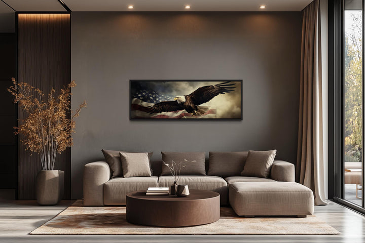 Horizontal wall art of a bald eagle flying over the American flag in a modern living room.