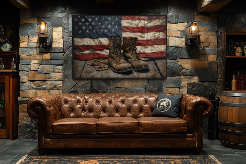 American flag and soldier boots wall art hanging above a brown leather sofa in a rustic room.