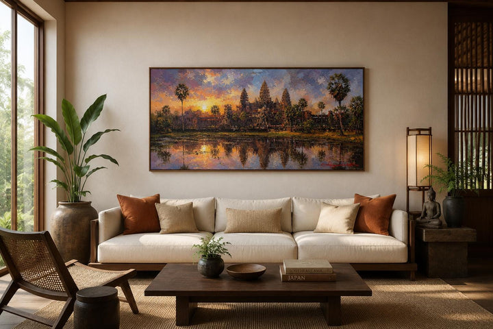 Angkor Wat sunset painting on canvas above a white sofa in a modern living room.