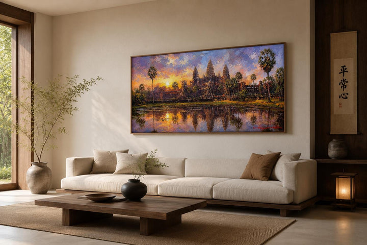 Angkor Wat sunset canvas wall art hanging above a modern sofa in a minimalist living room.