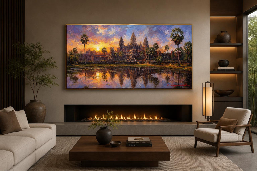 Angkor Wat wall art canvas showing a painted sunset over the Cambodian temple above a fireplace.