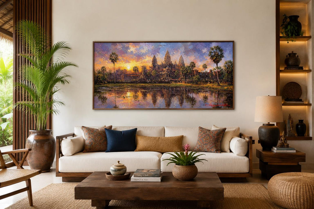 Angkor Wat wall art canvas showing the Cambodian temple at sunset above a living room sofa.