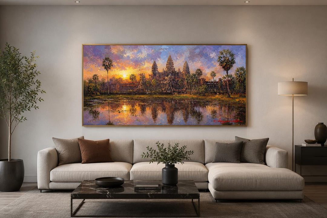 Angkor Wat sunset painting on canvas hanging above a modern sofa in a living room.