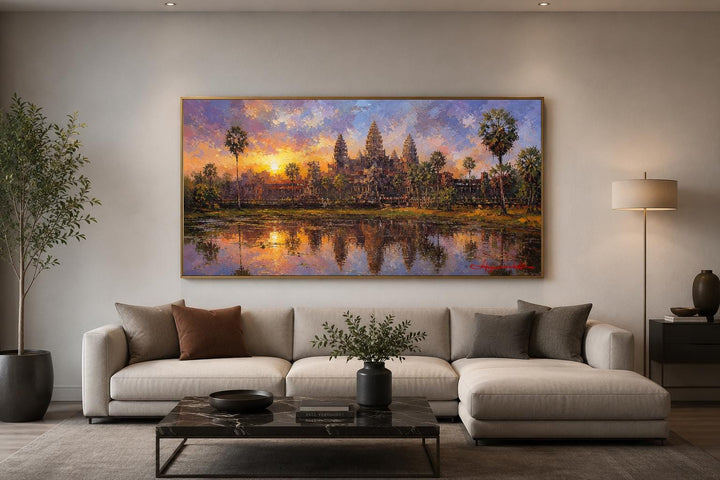 Angkor Wat sunset painting on canvas hanging above a modern sofa in a living room.