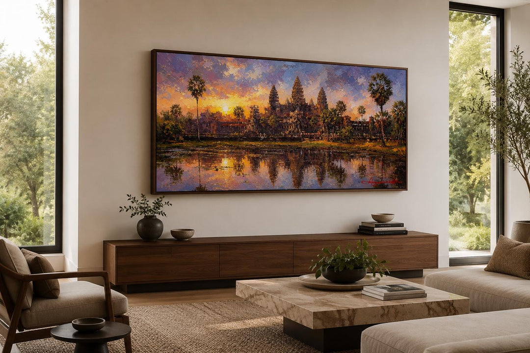 Angkor Wat sunset painting on canvas, framed and hung above a wooden console in a modern living room.