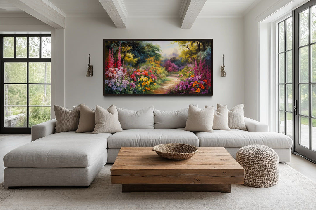 Antique flower garden framed canvas wall art above a neutral sectional sofa in a bright living room.