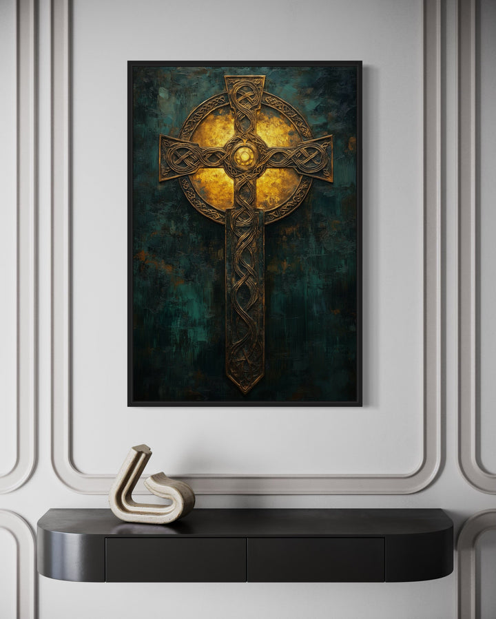 Framed canvas wall art of an intricate gold Celtic cross on a dark green textured background.