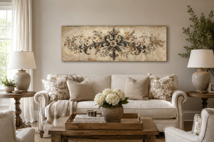 Antique neutral long narrow damask canvas wall art featuring ornamental scrollwork above a sofa.