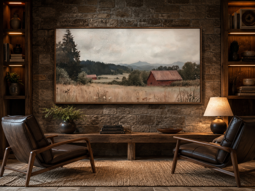 Framed antique red barn canvas print on a stone wall between two wooden bookshelves.