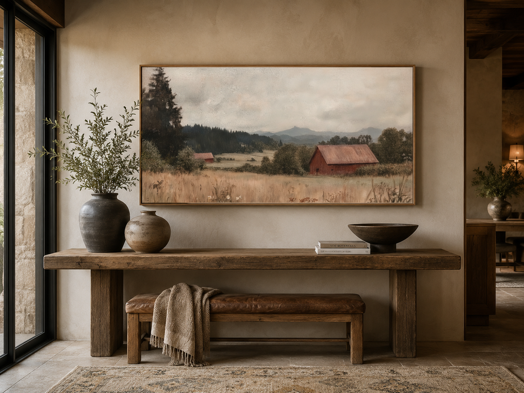 Antique red barn art in a thin wood frame hanging above a rustic wooden console table.