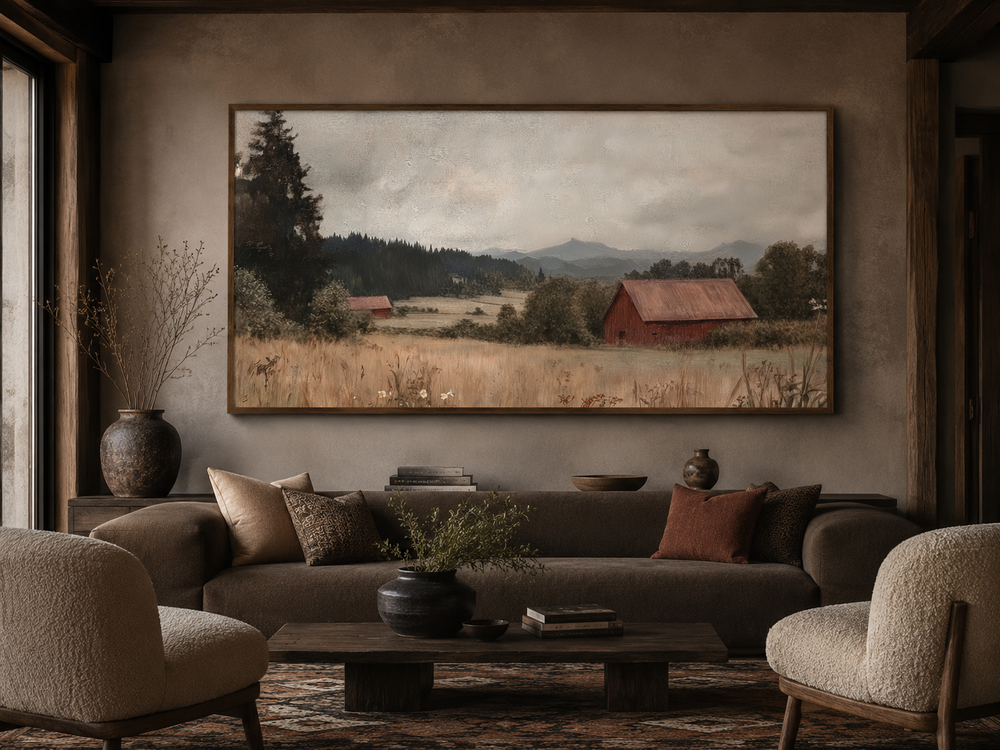 Framed antique red barn canvas print in a rustic living room above a brown sofa.