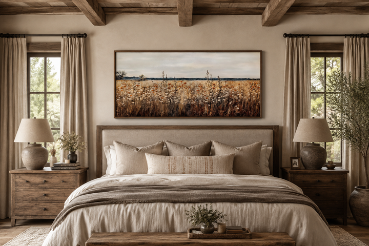 Antique rustic wildflowers field framed canvas wall art hanging above a bed in a farmhouse bedroom.