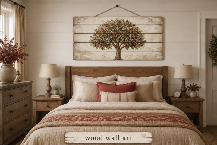 Rustic wood wall art featuring a painted apple tree hanging above a bed in a farmhouse bedroom.