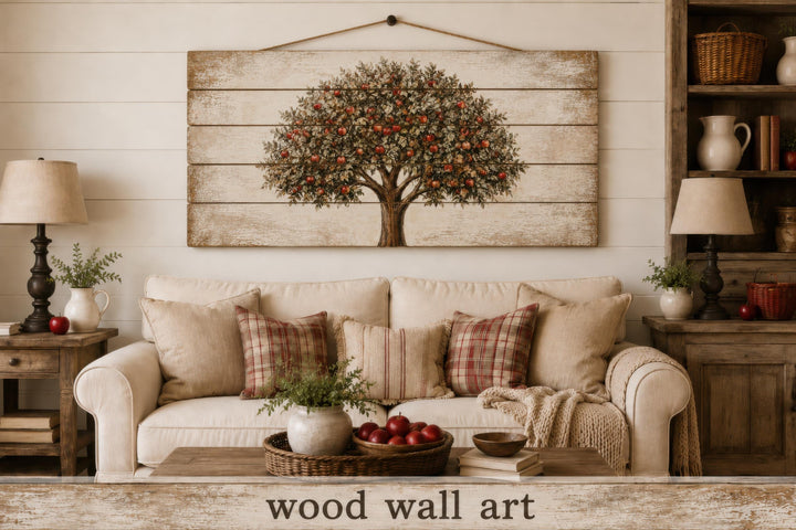 Rustic wood wall art featuring a painted apple tree hanging above a neutral farmhouse sofa.