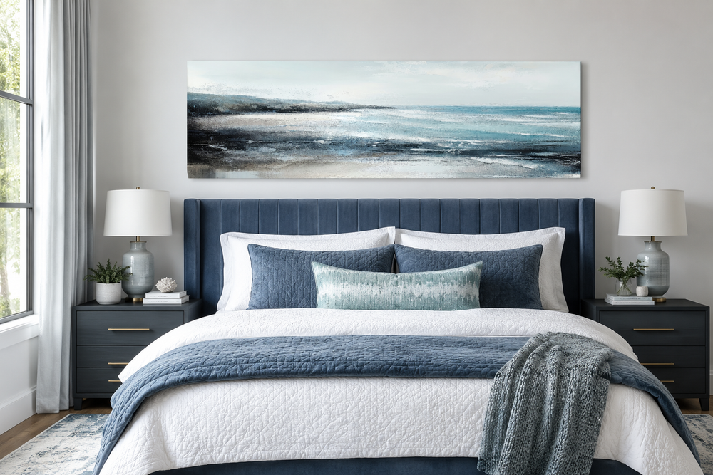 Aqua blue ocean beach coastal panoramic canvas wall art hanging over a bed in a modern bedroom.
