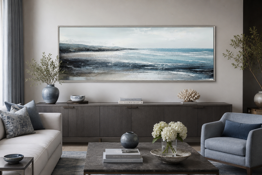 Aqua blue ocean beach coastal framed canvas wall art in a panoramic format over a dark wood console.