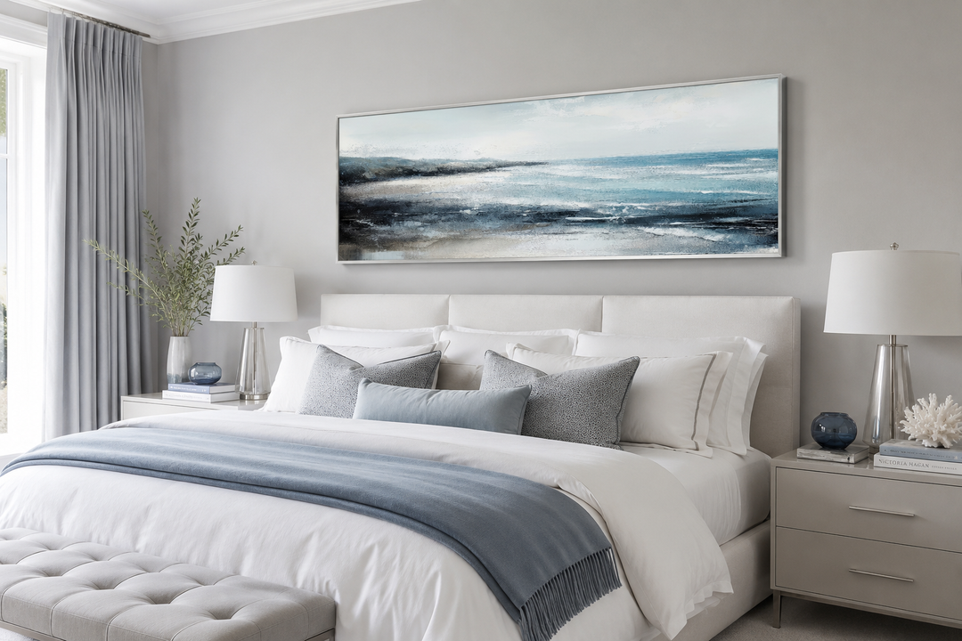 Aqua blue ocean beach coastal framed canvas wall art hanging over a bed in a neutral bedroom.