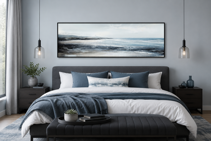 Panoramic aqua blue ocean beach framed canvas wall art hanging over a modern bed.
