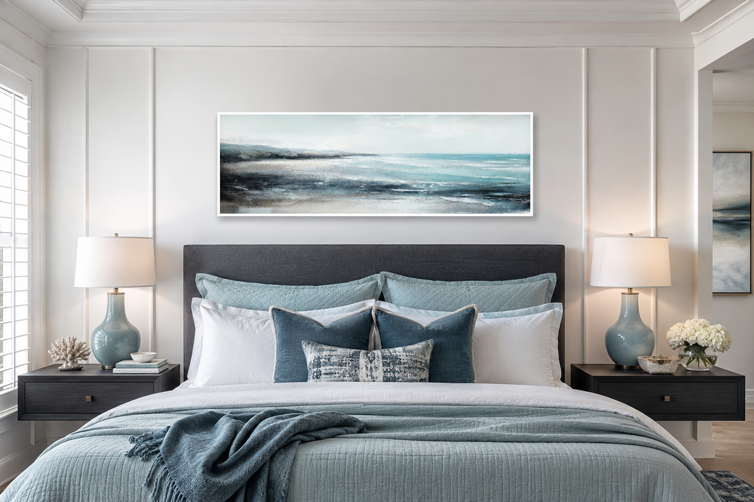 Aqua blue ocean beach coastal framed canvas wall art displayed over a bed in a serene bedroom.
