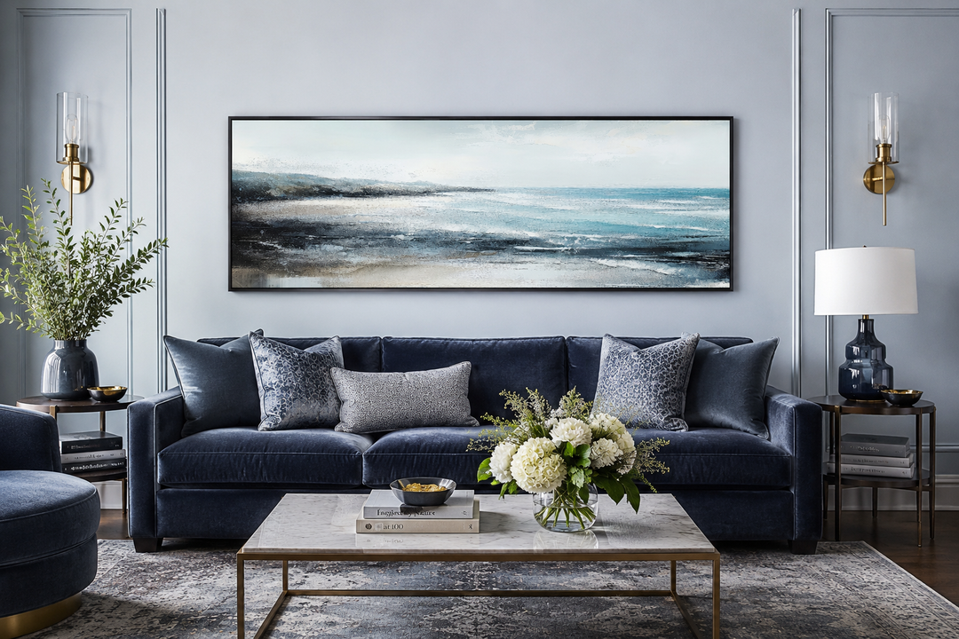 Aqua blue ocean beach coastal framed canvas wall art hanging over a navy velvet sofa.