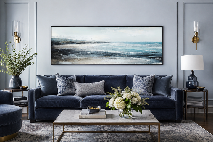 Aqua blue ocean beach coastal framed canvas wall art hanging over a navy velvet sofa.