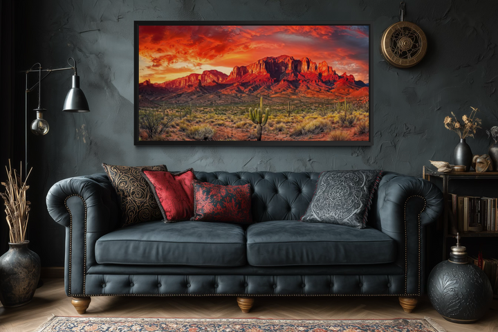 Arizona desert landscape at sunset framed canvas wall art hanging above a dark blue tufted sofa.