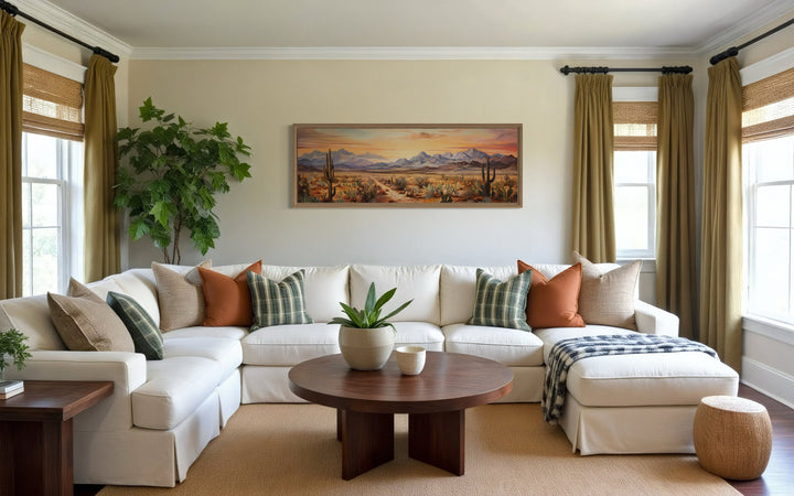 Arizona desert landscape at sunset long horizontal framed canvas wall art above a white sectional.