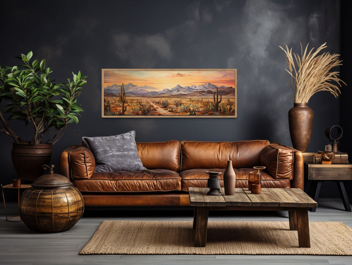 Arizona desert landscape at sunset long horizontal framed canvas wall art above a leather sofa.