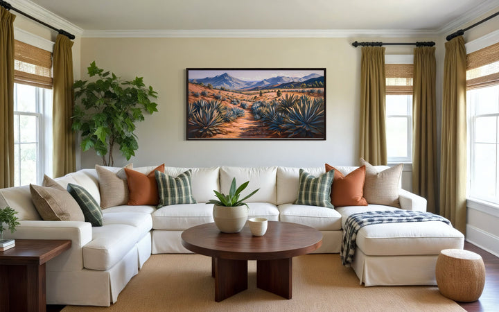 Arizona desert landscape with agave plants framed canvas wall art above a white sectional sofa.