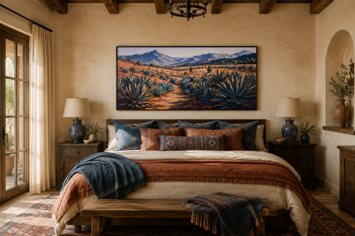 Framed canvas wall art of an Arizona desert landscape with agave plants above a bed.
