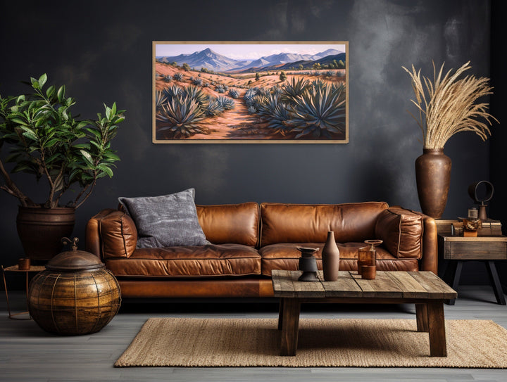 Arizona desert landscape framed canvas wall art featuring agave plants above a leather sofa.