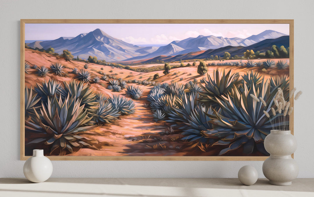 Framed canvas wall art of an Arizona desert landscape with agave plants and distant mountains.
