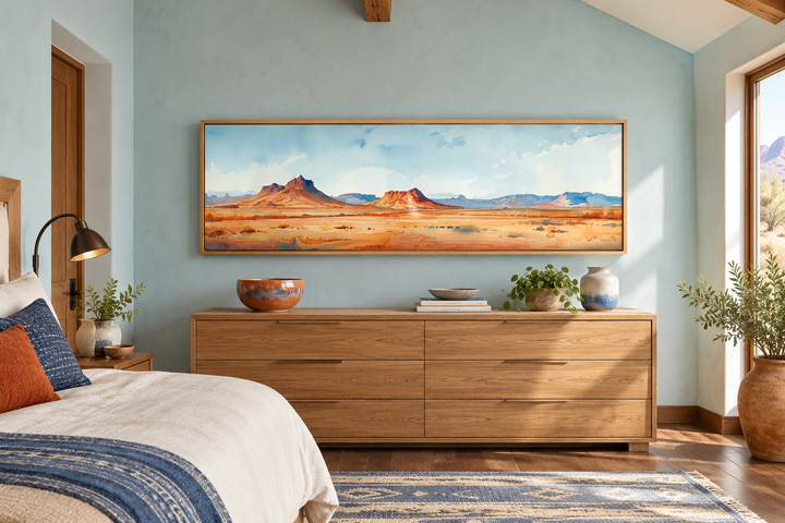 Horizontal framed canvas art of a minimalist Arizona desert landscape above a wooden dresser.