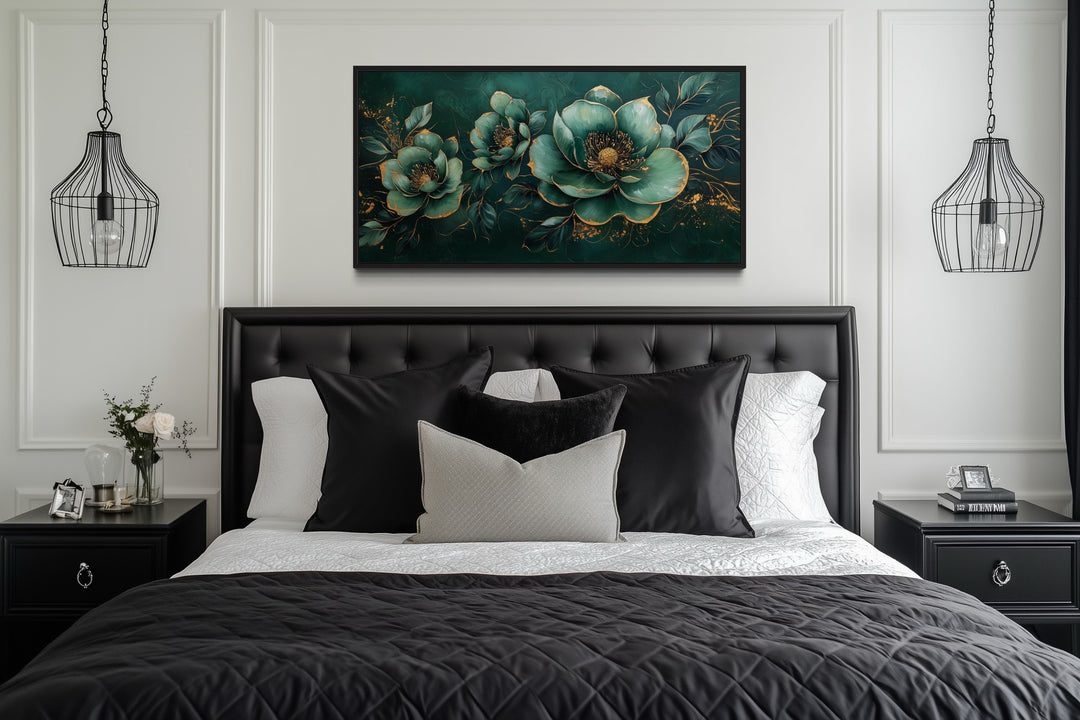 Emerald green and gold floral canvas print centered above a black tufted headboard in a bedroom.