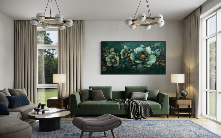 Emerald green and gold floral canvas print centered above a green sofa in a modern living room.