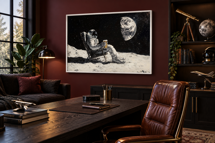 Astronaut on the moon drinking beer framed canvas wall art in a dark, sophisticated office setting.