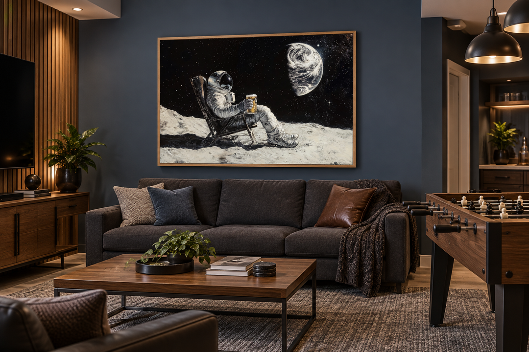 Framed canvas wall art of an astronaut drinking beer on the moon in a modern dark blue living room.