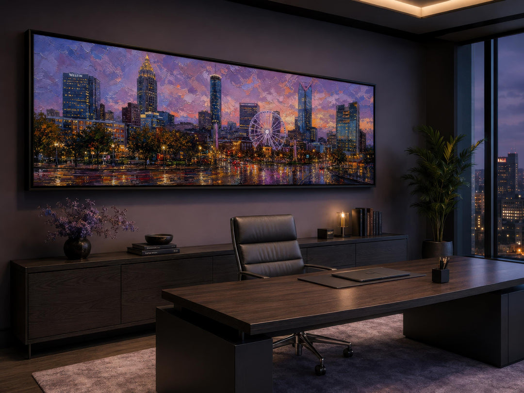 Panoramic Atlanta skyline canvas art above a desk in a modern office with sunset cityscape colors.