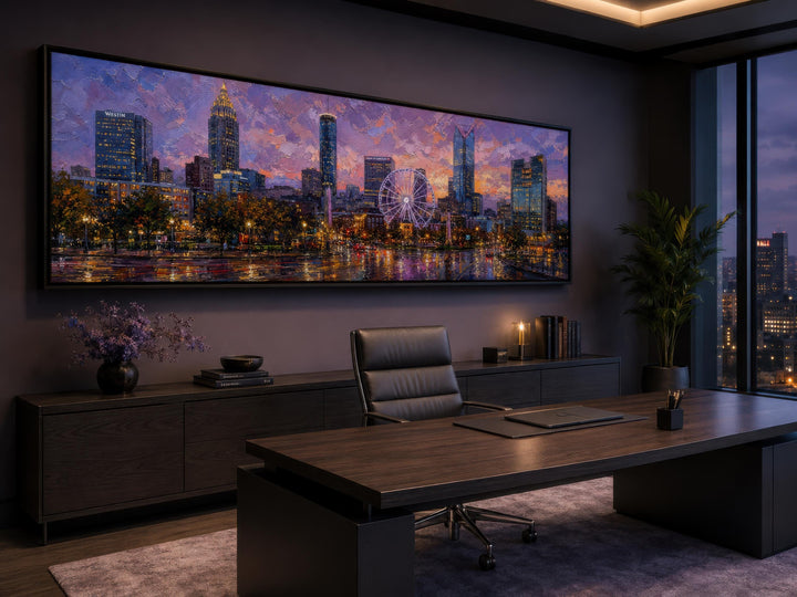 Panoramic Atlanta skyline canvas art above a desk in a modern office with sunset cityscape colors.
